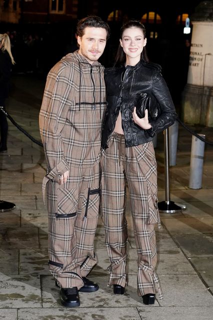 Brooklyn Beckham (left) and Nicola Peltz arriving at the Burberry show at Tate Britain, London (Ian West/PA)