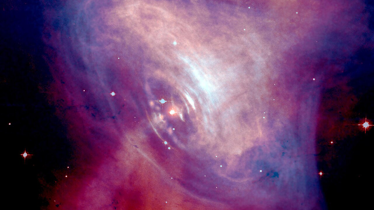 A red-and-blue image of a nebula is shown, shaped somewhat like an eye, with a plume of gas emitting from the center.