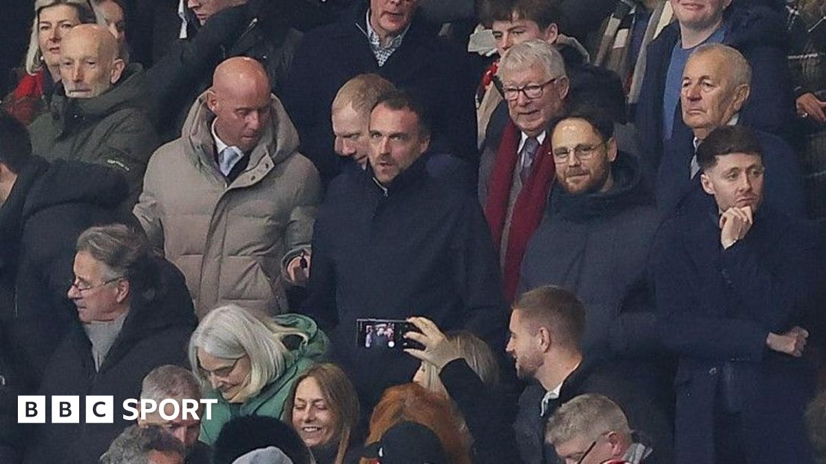 Nicky Butt (grey coat) and Paul Scholes to his left sat with former manager Sir Alex Ferguson (red scarf) at Manchester United's FA Cup defeat by Brighton