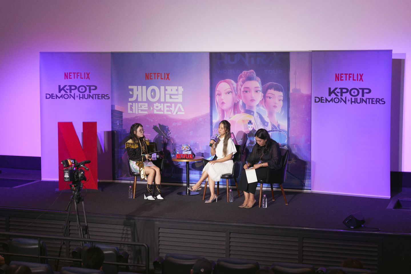 Netflix's animated film ″KPop Demon Hunters″ director Maggie Kang, center, attends a press conference held in Yongsan District, central Seoul, on Aug. 22, 2025. [NETFLIX]