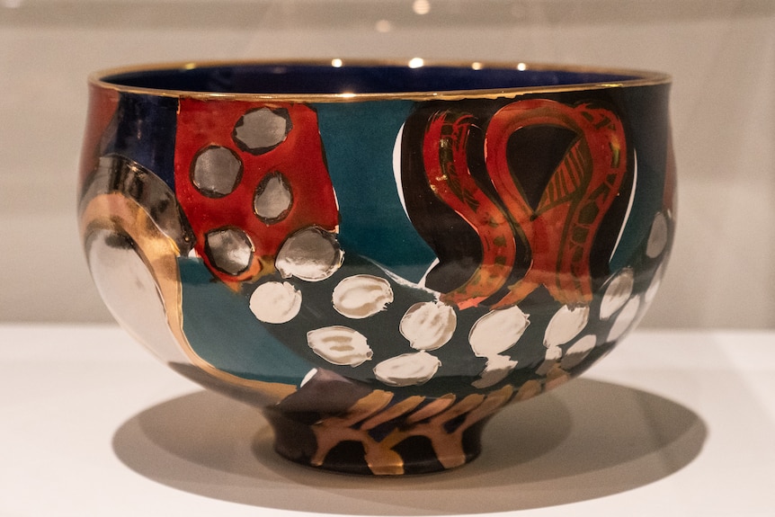 large bowl with deep colour, red, green, gold and silver