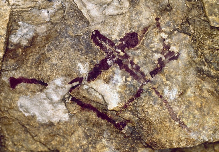 A cave painting depicting a single stick figure wielding a bow and arrow.