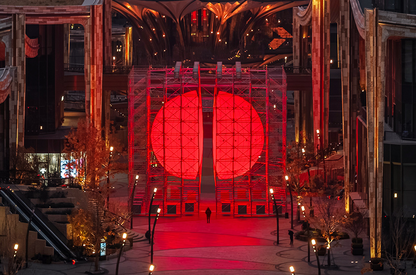 SpY's monumental divided sphere installation illuminates xi’an in bright red light