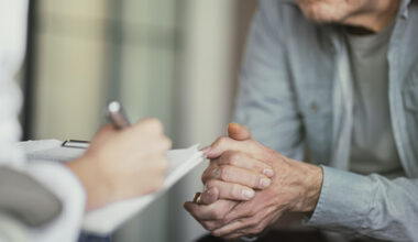 Doctor talks with patient and takes notes