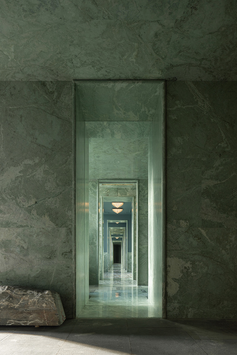 green marble clads gallery showroom’s immersive interiors in shenzhen