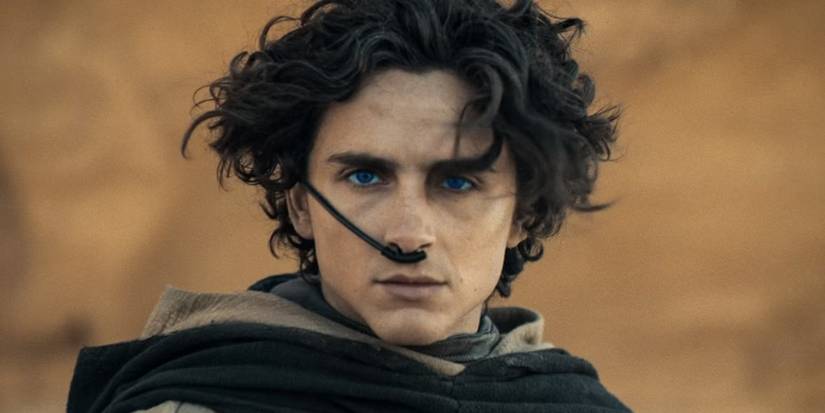 Timothée Chalamet as Paul Atreides with a breathing tube looking at the camera in Dune: Part Two.