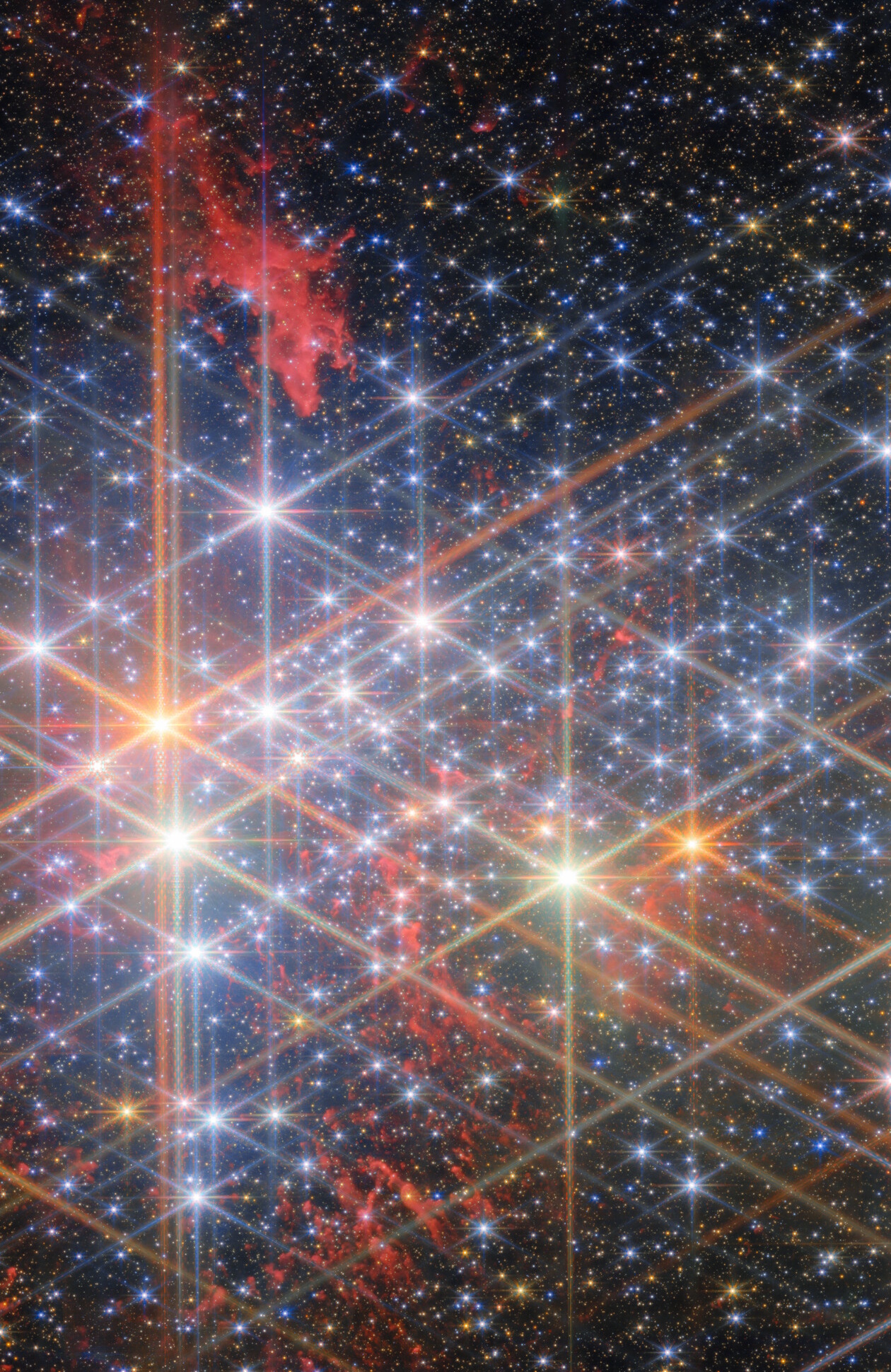 A dense star field with hundreds of bright stars, some with visible diffraction spikes, and red nebula clouds in the background, capturing a scene like a JWST reveal of the universe in deep space.