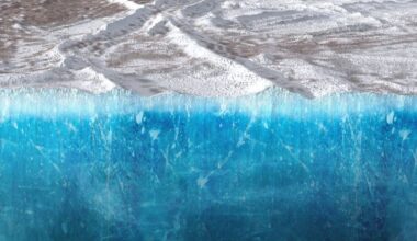 This illustration shows a cut-away view of Europa's icy shell, with the gas giant Jupiter in the background. New research shows that the icy shell is up to 39 km thick. That's a significant barrier to life-supporting surface chemicals reaching the ocean. Image Credit: NASA/JPL-Caltech/SwRI/Koji Kuramura/ Gerald Eichstädt (CC BY)