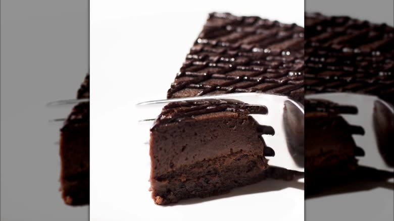 Fork slicing into flourless chocolate torte