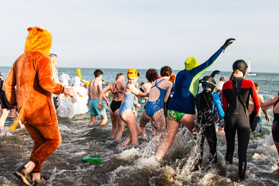 A moment of icy bravery as swimmers plunge into the cold sea, diving into the New Year with excitement. (Photo by: Hannah Daygo)