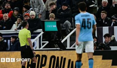 Chris Kavanagh at the pitch-side VAR monitor