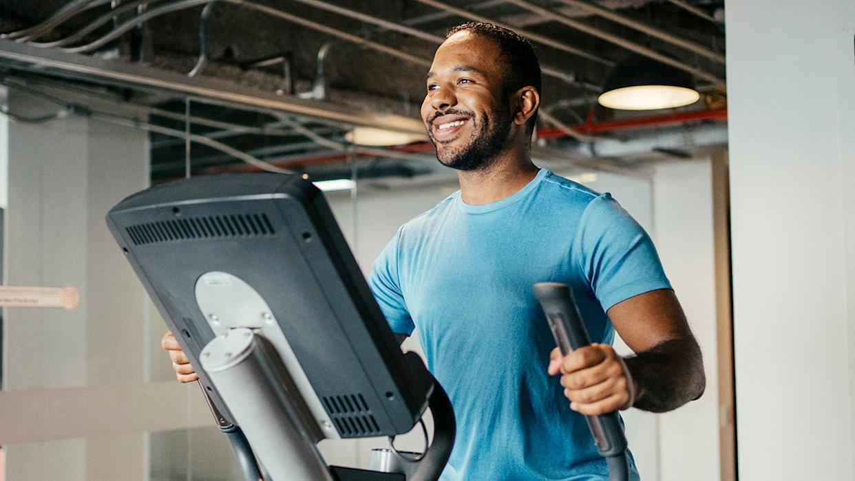 man smiling on an eliptical