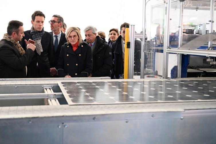 People look at solar panels
