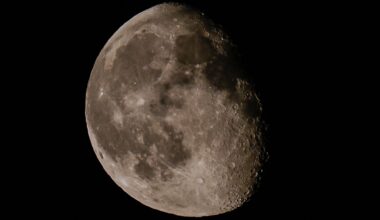 The moon is pictured in a black night sky, with a portion of its right side bathed in shadow.