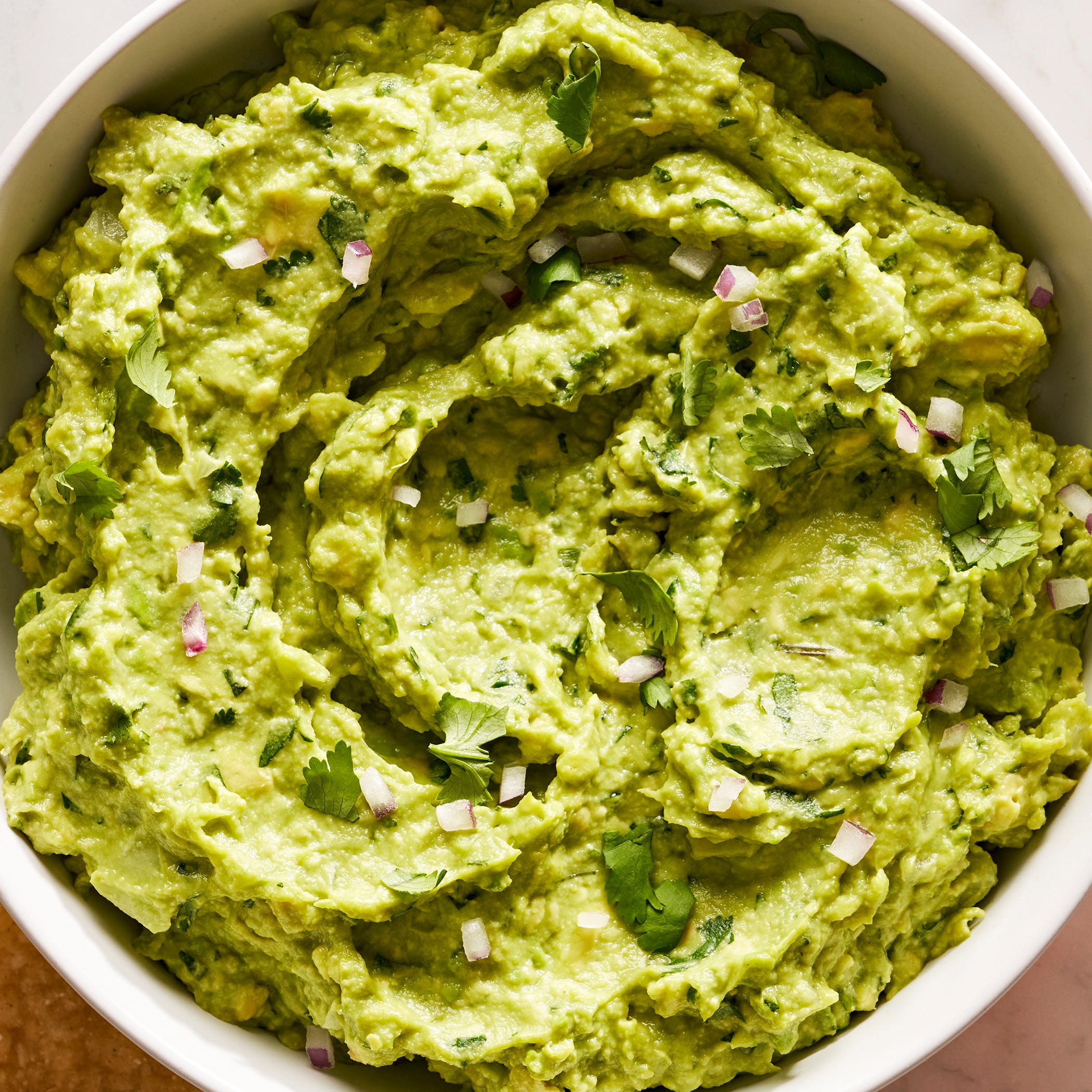 guacamole with diced red onion, cilantro, and with chips