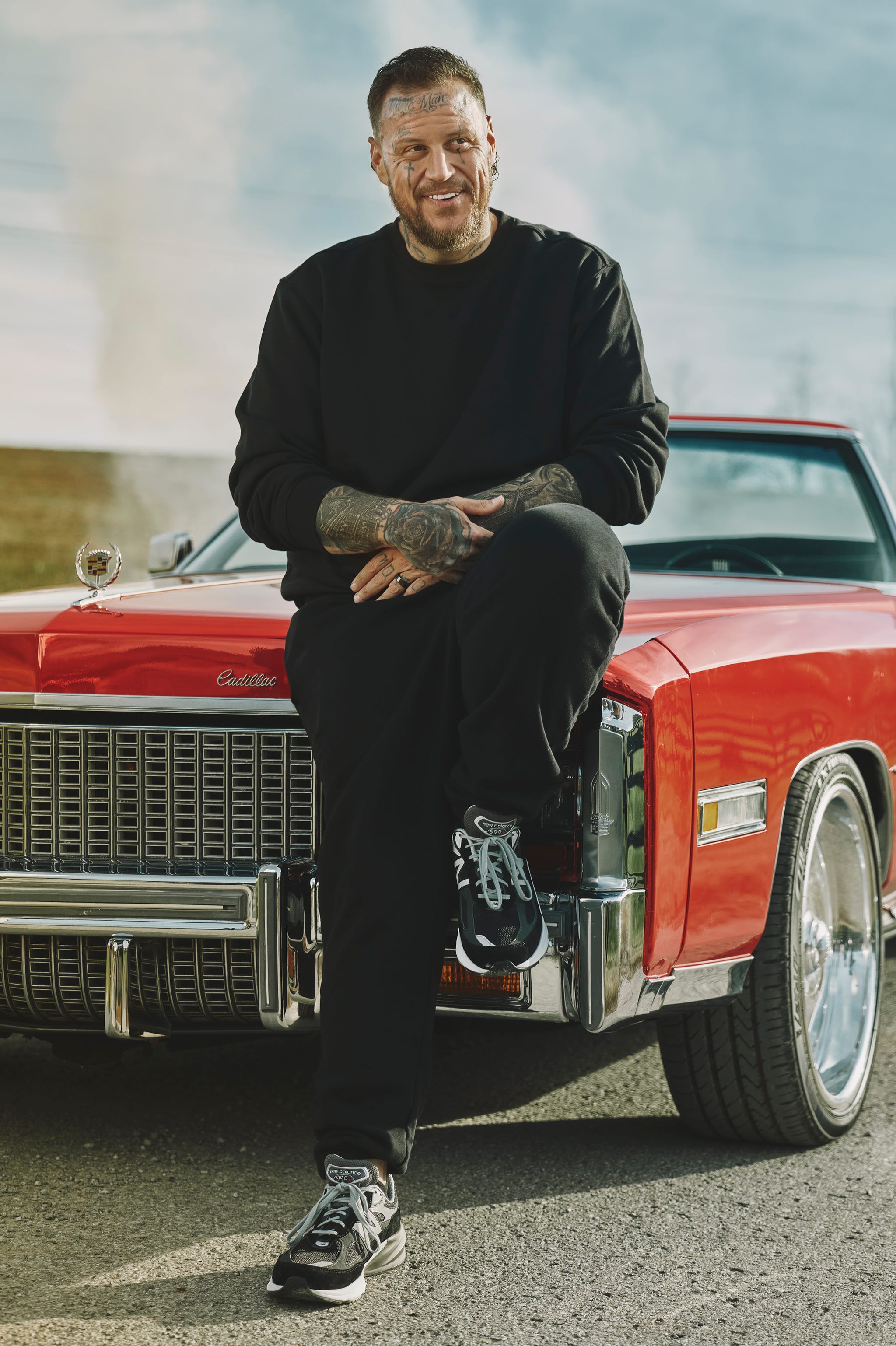 person sitting on a classic red cadillac person sitting on a classic red cadillac