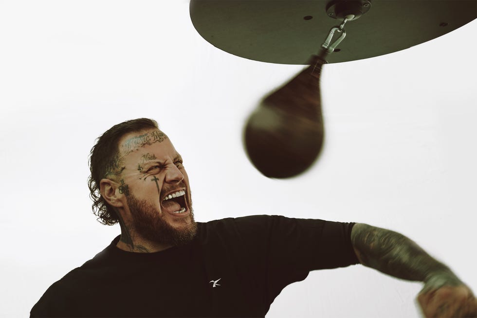 jelly roll working out throwing punches at a boxing speed bag. jelly roll working out throwing punches at a boxing speed bag.