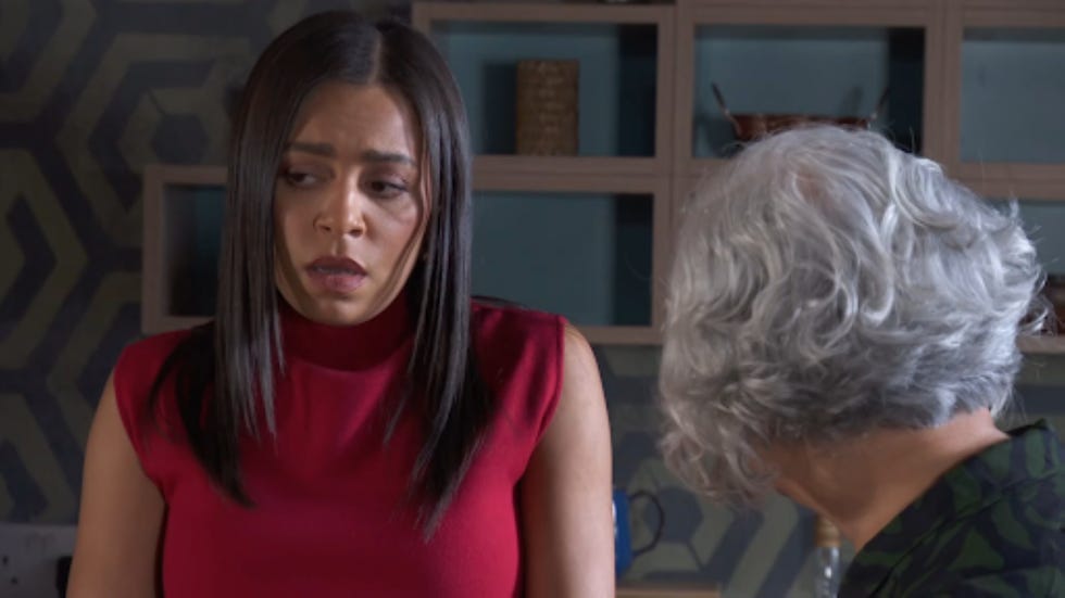 two women engaged in conversation indoors