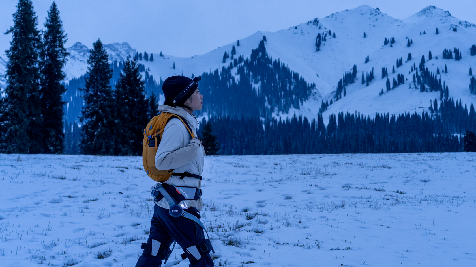 Hypershell X woman walking through snowy landscape