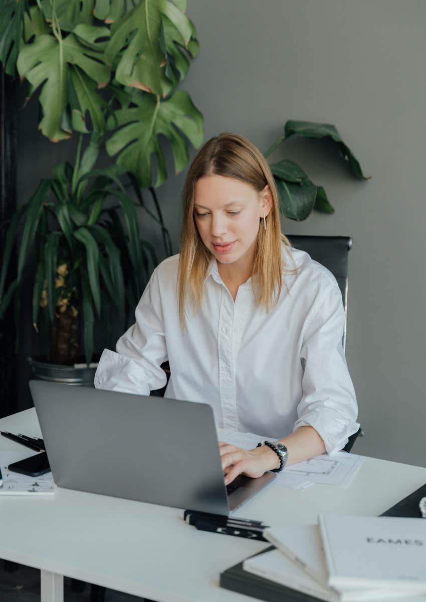 woman working in an office at a traditional job