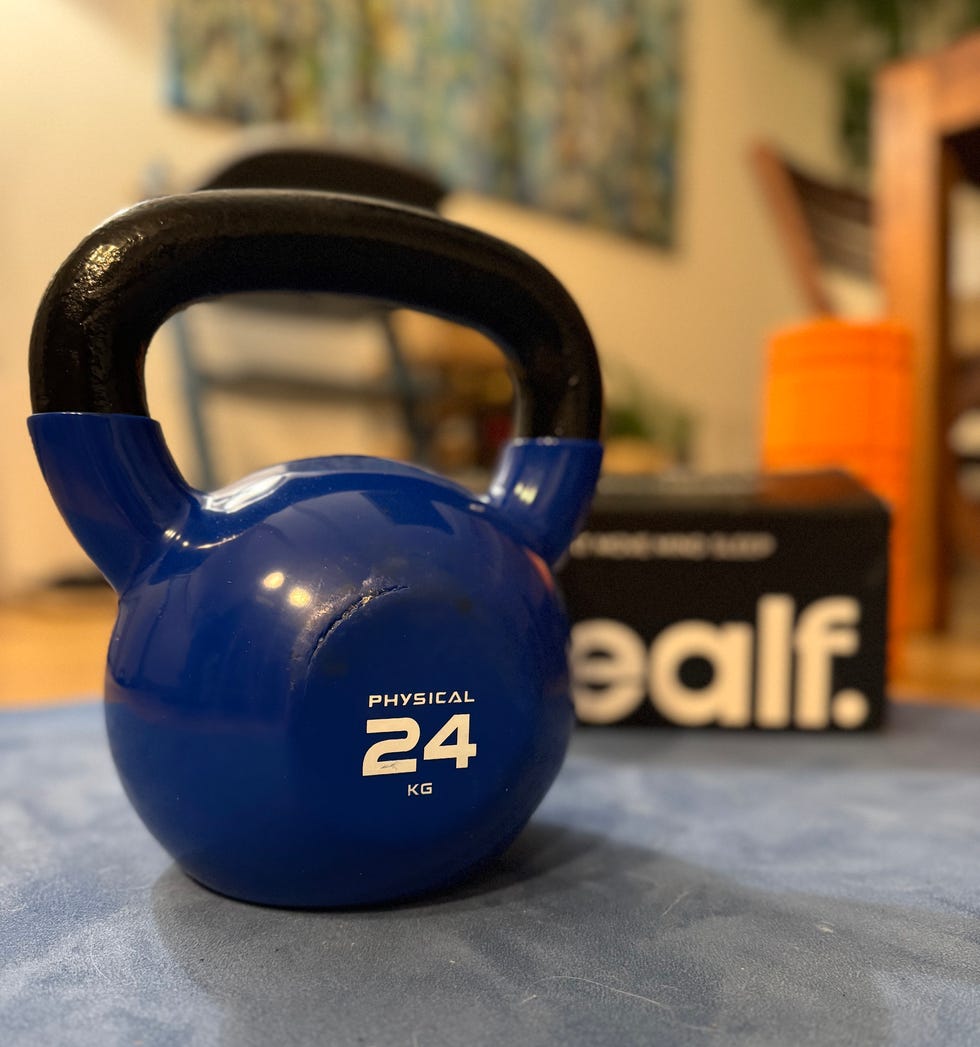blue kettlebell labeled as 24 kg with a black handle blue kettlebell labeled as 24 kg with a black handle