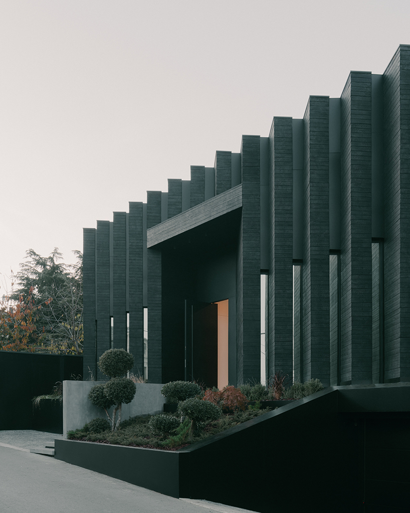 serrated charred wood shell encloses suburban residence on the hills of tbilisi