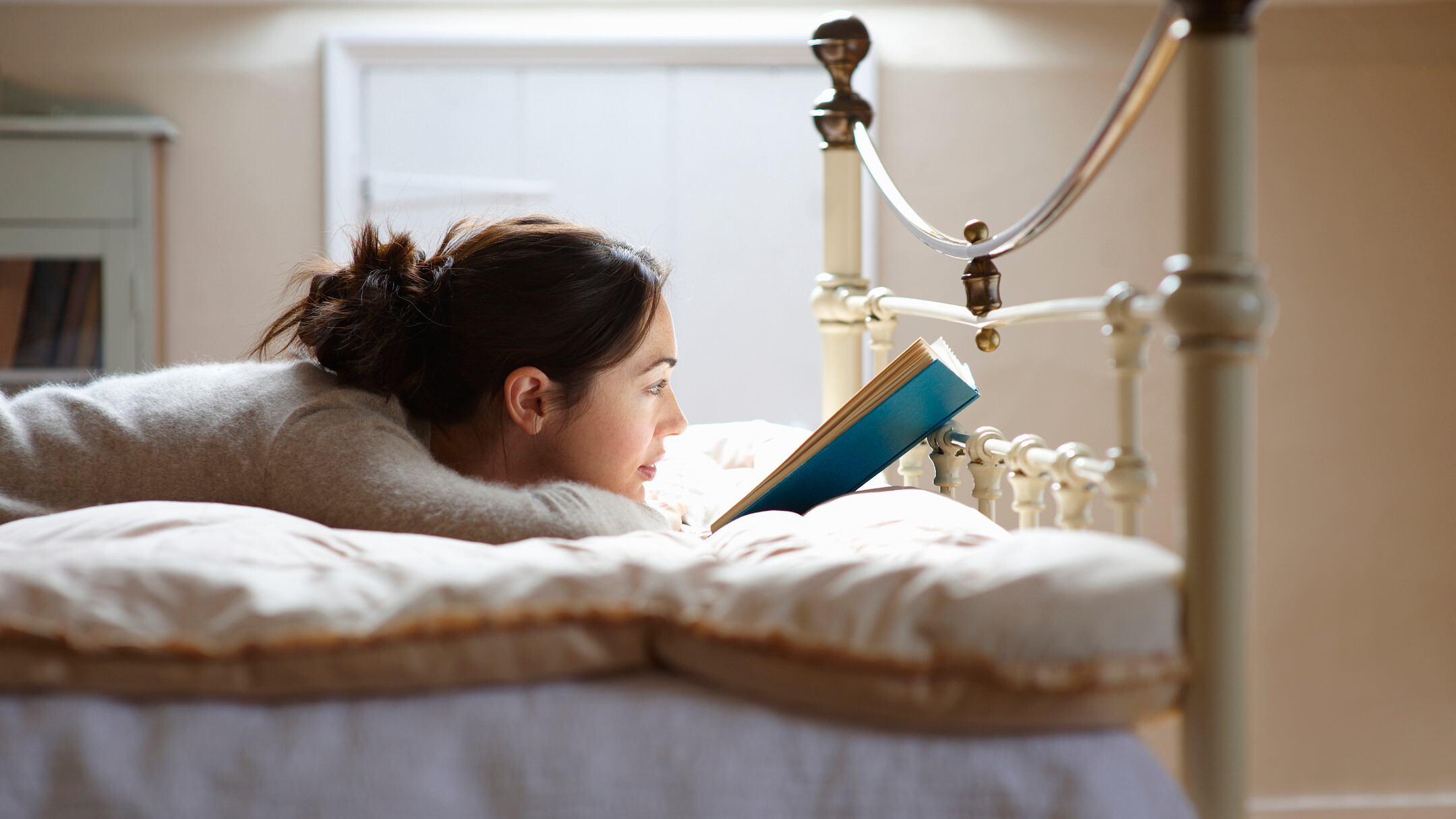 Woman reading in bed