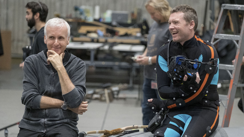 James Cameron behind the scenes with Sam Worthington in his motion capture suit while filming Avatar: The Way of Water