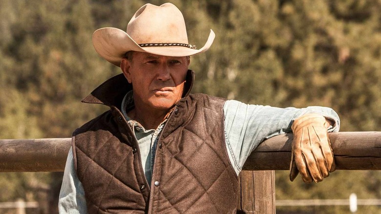 Kevin Costner as John Dutton leaning against a fence on Yellowstone