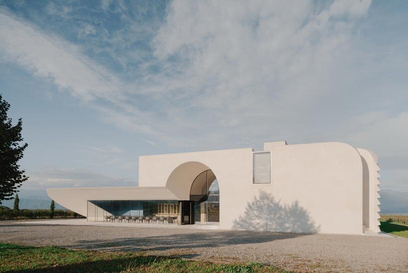 arches and voids carve winery’s monolithic white facade in georgia