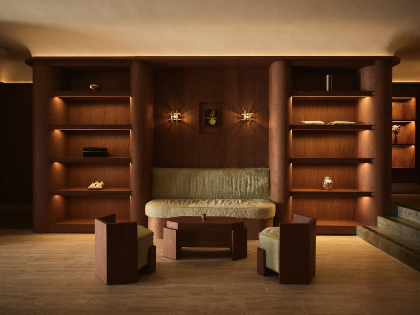 Shoes and accessories displayed on softly illuminated wood shelves either side of a built-in bench