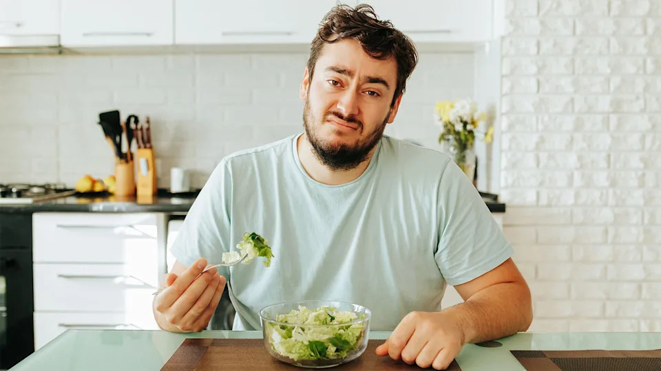 man eating a salad.