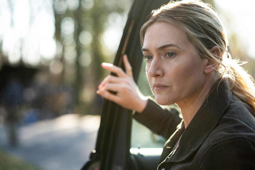 Kate Winslet in Mare of Easttown kate winslet climbing out of a car in mare of easttown