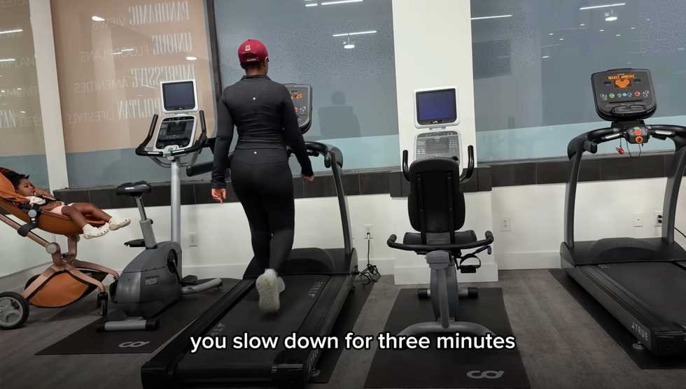 individual walking on a treadmill in a gym setting