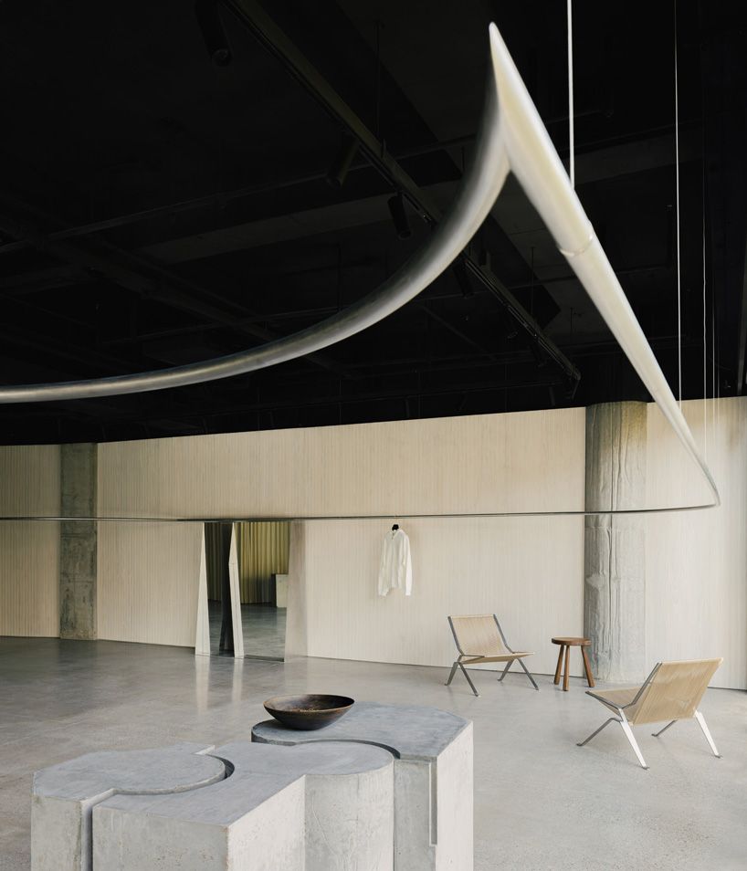 continuous steel rail traces shanghai showroom’s sculptural interior, like a freehand drawing