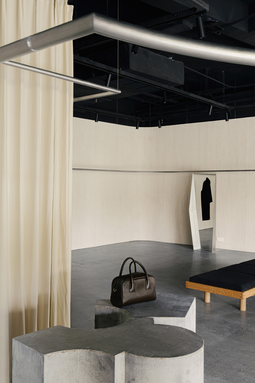 continuous steel rail traces shanghai showroom’s sculptural interior, like a freehand drawing