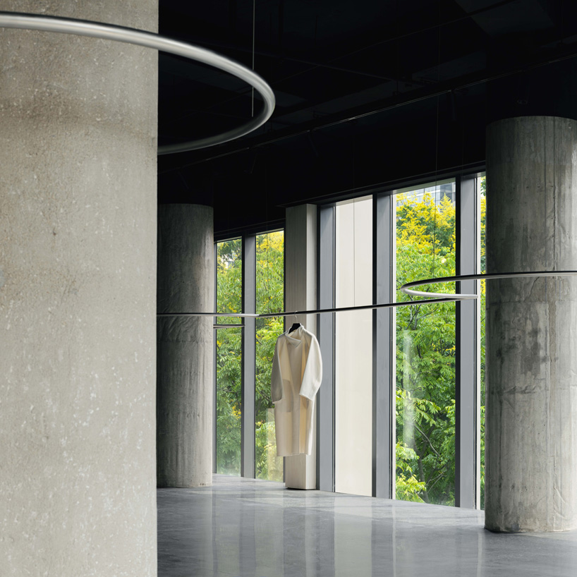 continuous steel rail traces shanghai showroom’s sculptural interior, like a freehand drawing