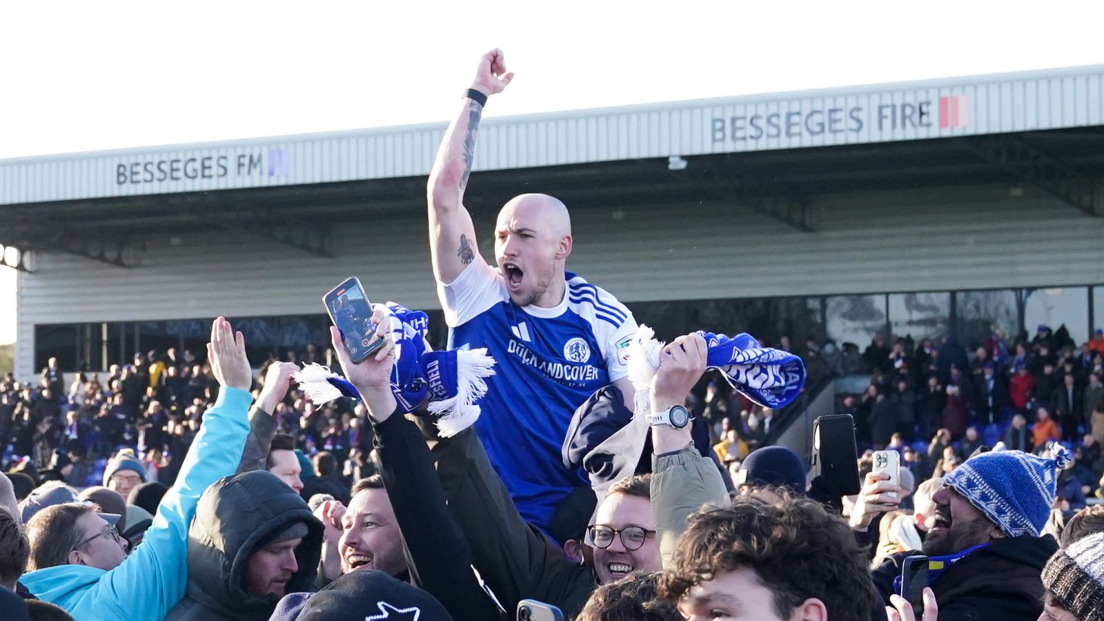 Macclesfield Town's Josh Kay celebrates with fans following the 2-1 win over Crystal Palace. Pic: PA