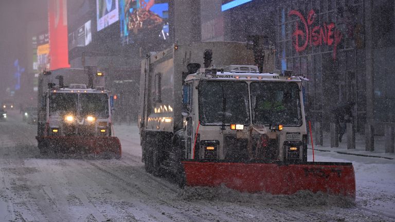 Garbage trucks with ploughs attached cleared the snow in Times Square. Pic: AP