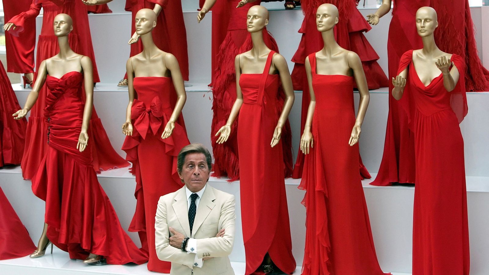 Valentino with some of his works in 2007 - sporting the designer's iconic 'Valentino red'. Pic: Reuters