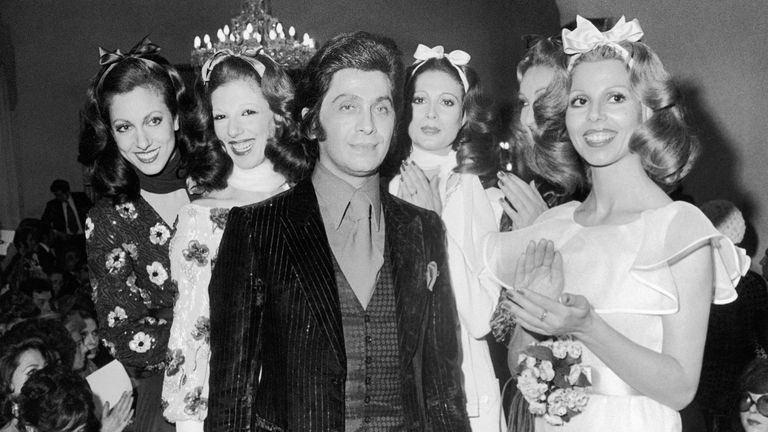 Valentino flanked by models after a fashion show in Rome in 1971. Pic: AP