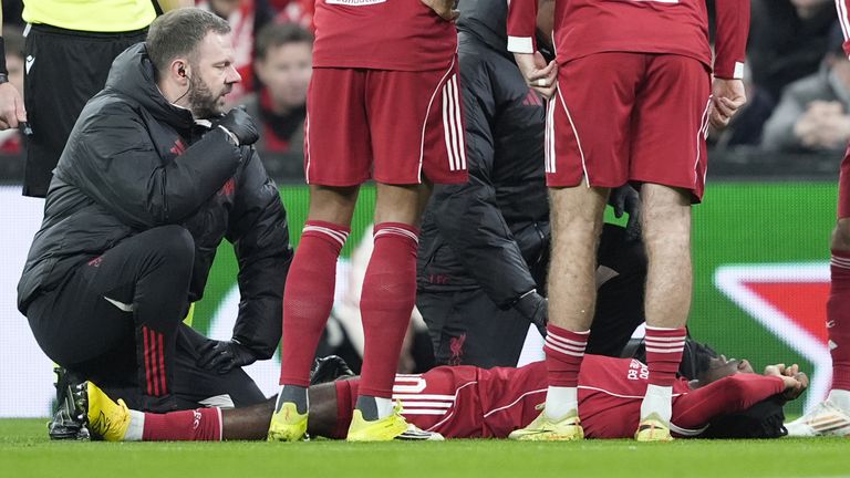 Liverpool's Jeremie Frimpong goes down injured early in the first half