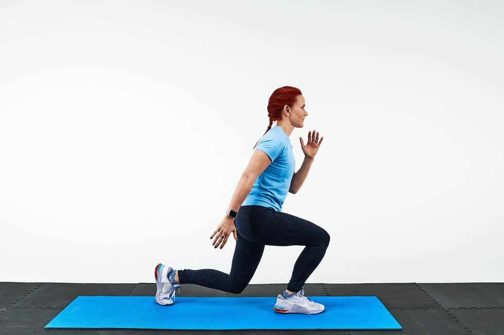person performing a lunge exercise on a blue exercise mat