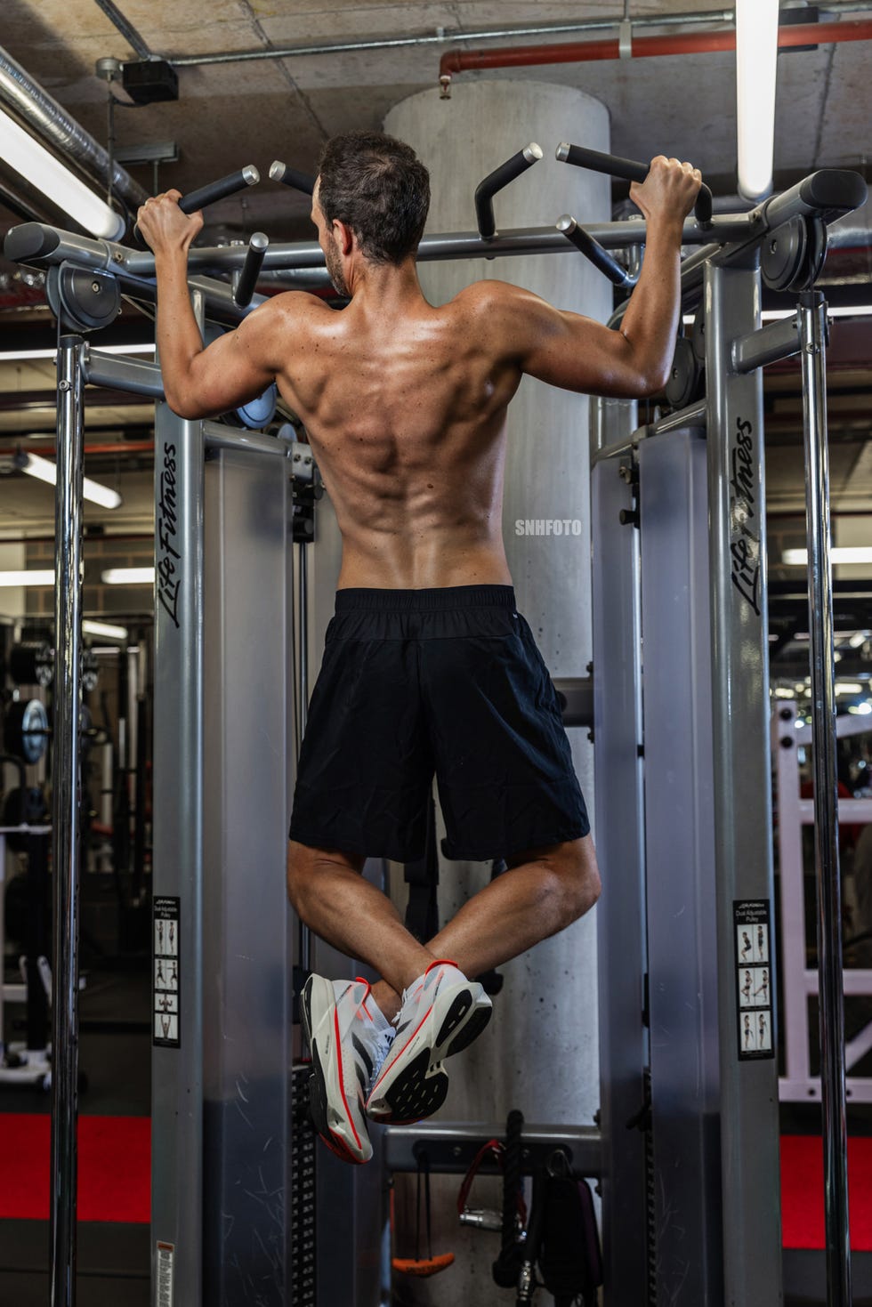 person performing pullups on a gym apparatus