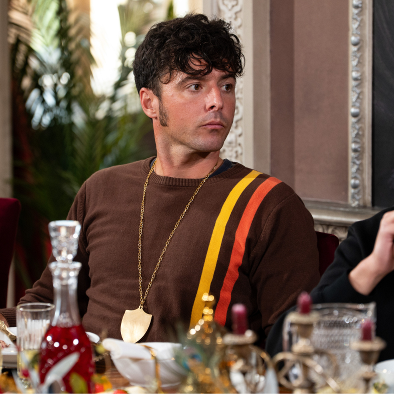person seated at a dining table with decorative items