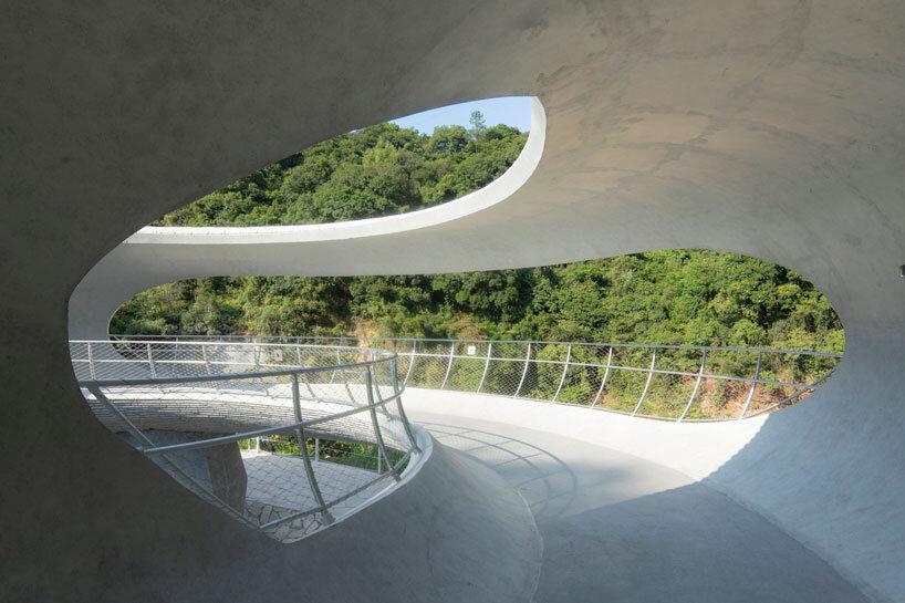 tubular concrete ring by HCCH studio shapes cycling rest pavilion among chinese hills