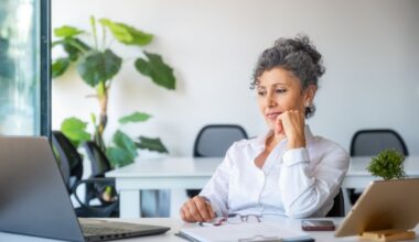 A person at a table with a laptop open.