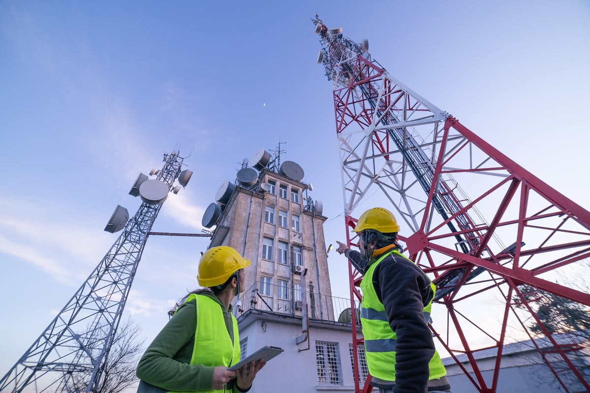Technicans working near wireless communications towers.