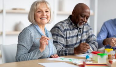 Two people working on an art project at a table.