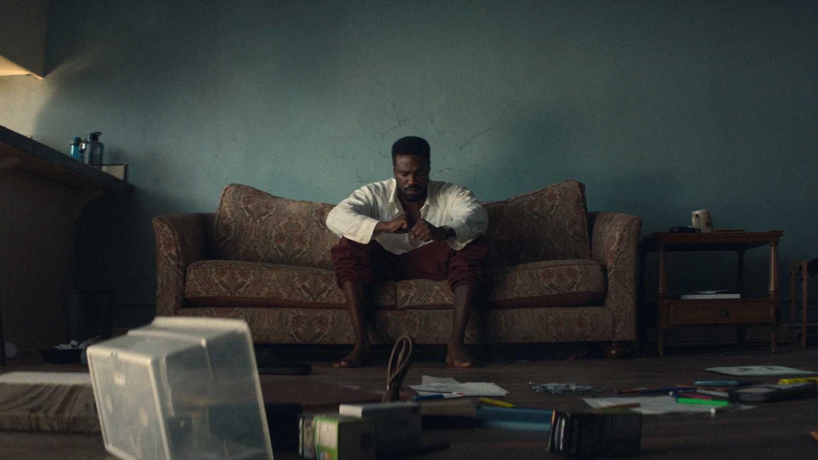 Yahya Abdul-Mateen II As Simon Williams Sitting On His Couch Surrounded By A Mess In Wonder Man